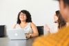 Two Ladies At A Table With One Laughing