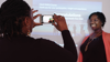 A Lady Taking A Photograph Of Another Woman
