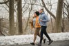 Male And Female Runing On A Road With Snow In The Background