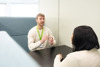 Two People Speaking At A Table (1)